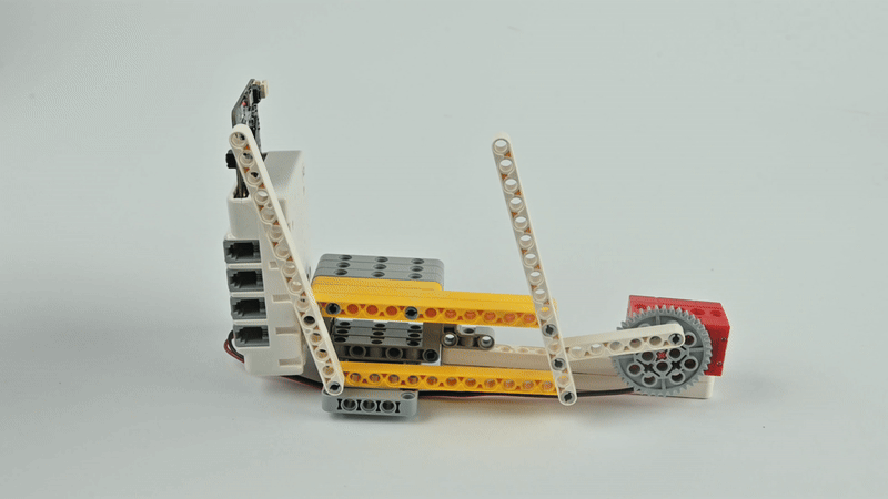 STEM robotics kit with motor and gear lever mechanism demonstrating engineering motion experiment