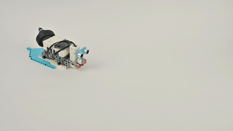 Steam Robotics Kit 110 obstacle avoidance car built with programmable blocks and ultrasonic sensor driving in motion