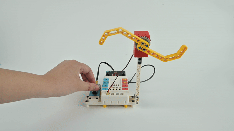 STEM robotics kit robotic arm controlled by buttons on a programmable module for hands-on engineering project