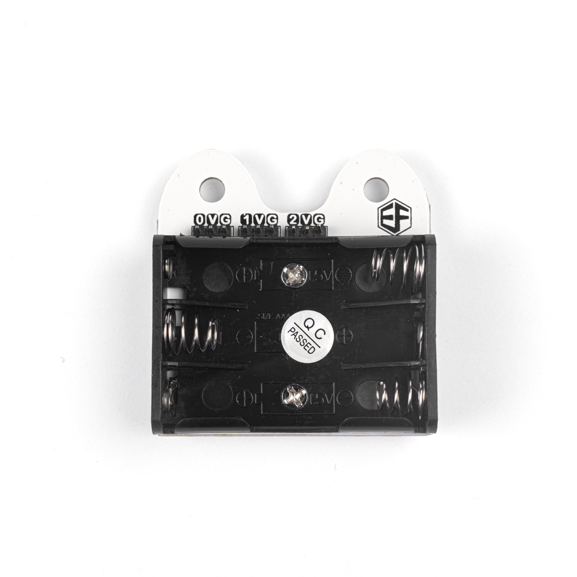 Back view of micro bit expansion board Ring:bit V2 showing 3 AAA battery holder with QC passed label