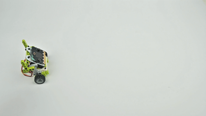 STEM robot car built with micro bit expansion board and building blocks, moving forward to demonstrate motor and sensor control